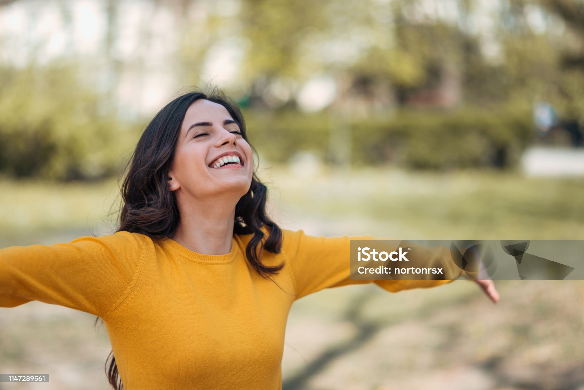 positive young woman enjoying springtime in the park,portrait.